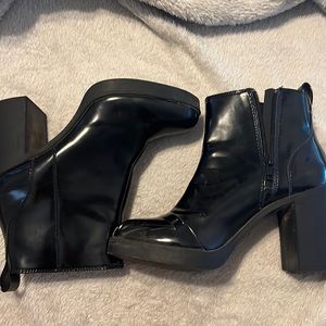 Divided, Slightly used, black shinny heeled boots slip on w/ zipper